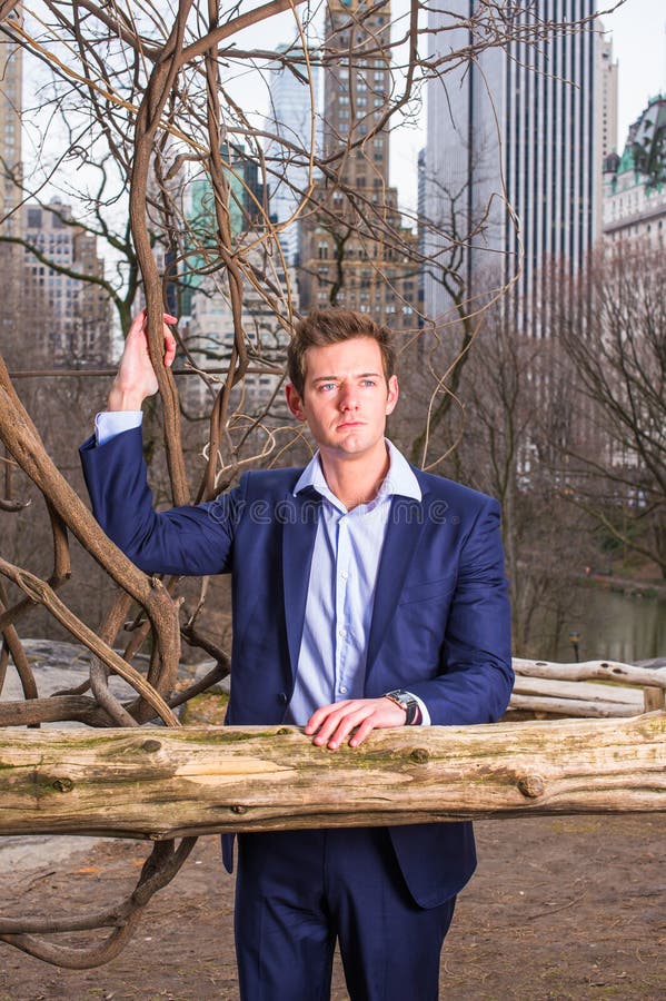 Young man standing outdoors in winter, looking forward stock photo
