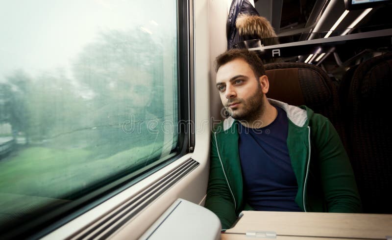 Young Man Looking Out Of Train Window Stock Photo - Download Image