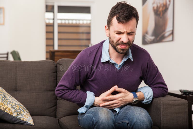 Young man with a stomach ache stock images