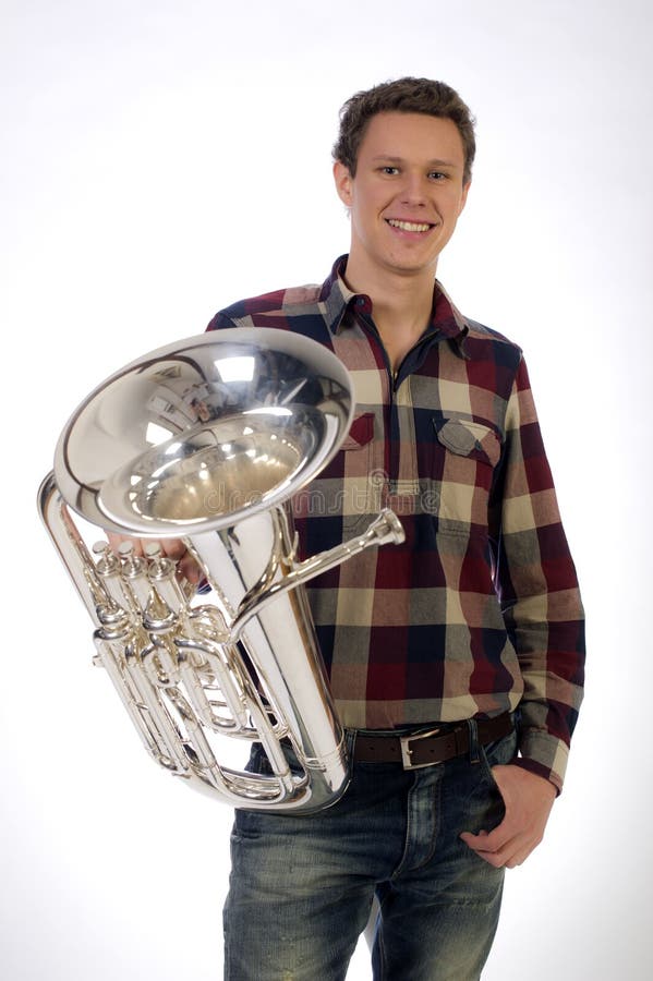 Young man in suit holding a trumpet horn