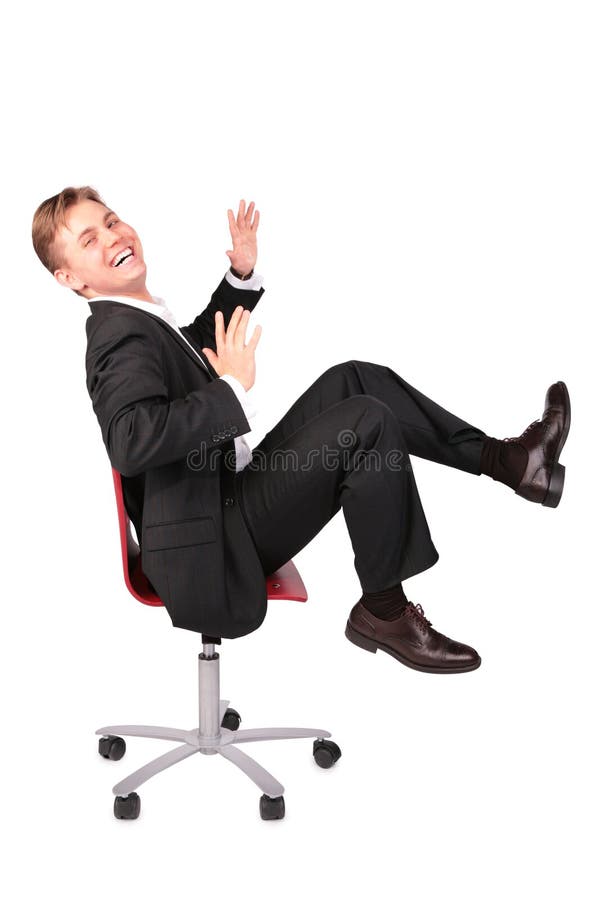 Young man in suit laugh sits on chair