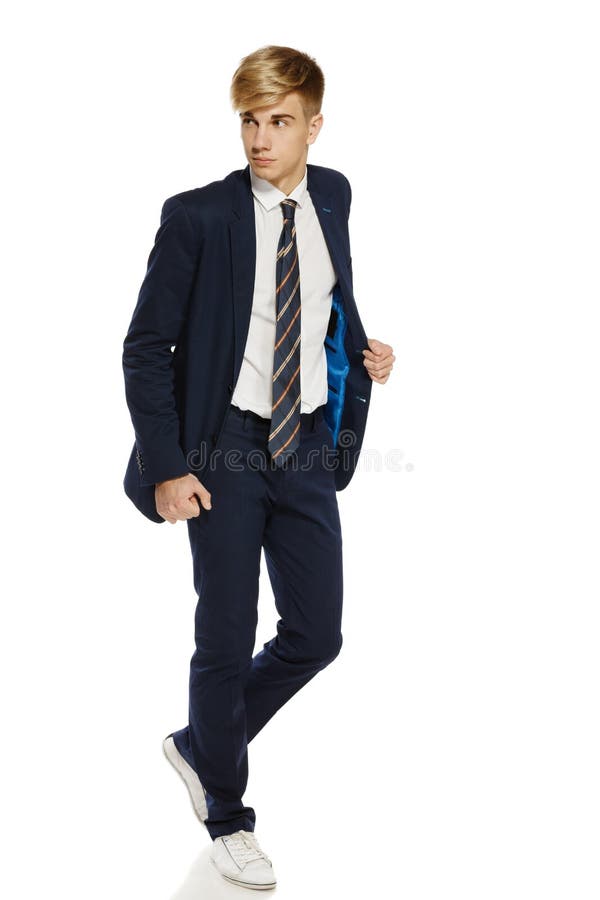 Young man in suit walking royalty free stock photos