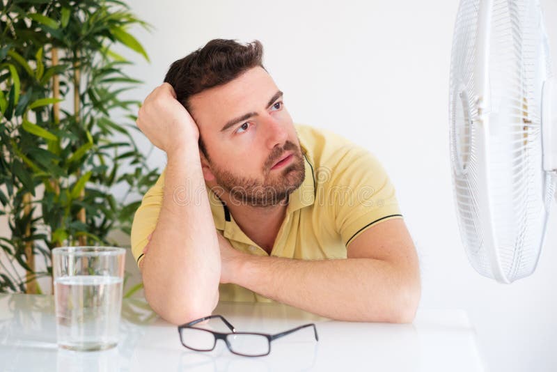 Young man suffering because summer heat haze