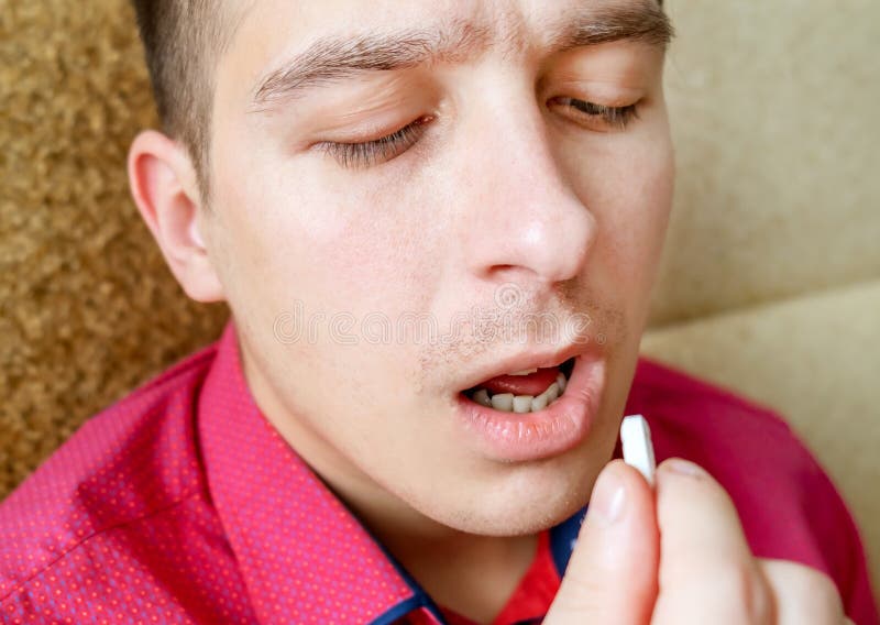 Young Man take a Pill stock photos