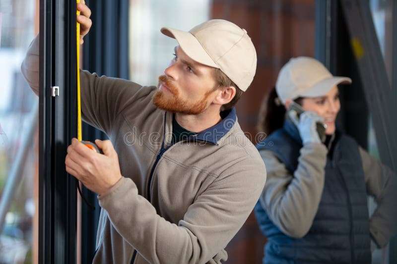 Young Man Taking Measure Window for Blinds Installation Stock Photo