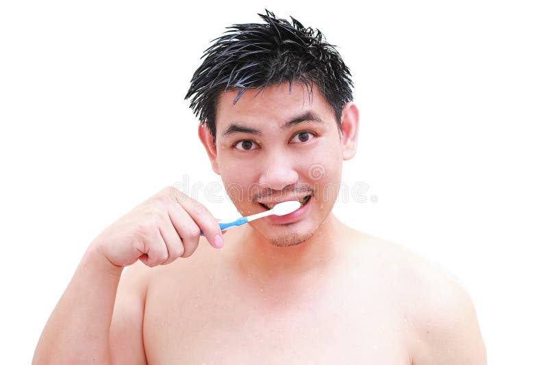 Young Man Taking a Shower and Standing Under Flowing Water in Bathroom
