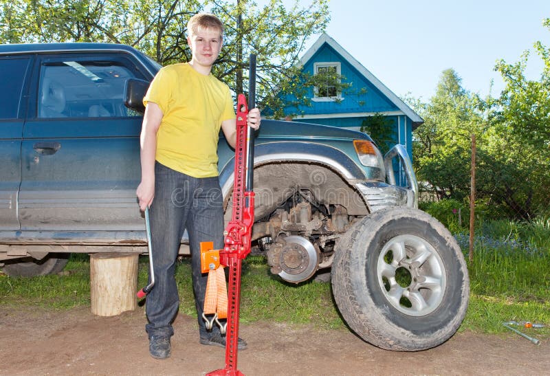 The Young Man, the Teenager Replaces a Wheel at an Off-road Car Stock ...