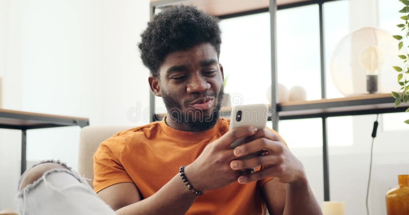 Young man text messaging using mobile phone stock footage
