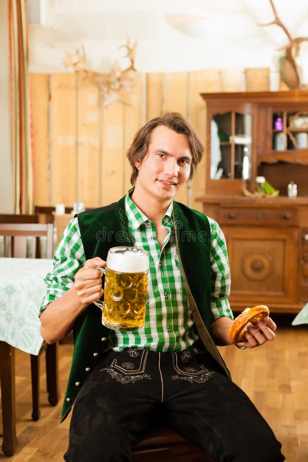 Young man in traditional Bavarian Tracht in restaurant or pub stock photography Young man in traditional Bavarian Tracht in restaurant or pub stock photography
