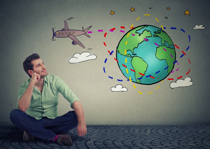 Young handsome man traveler sitting on floor thinking about an amazing trip around the world