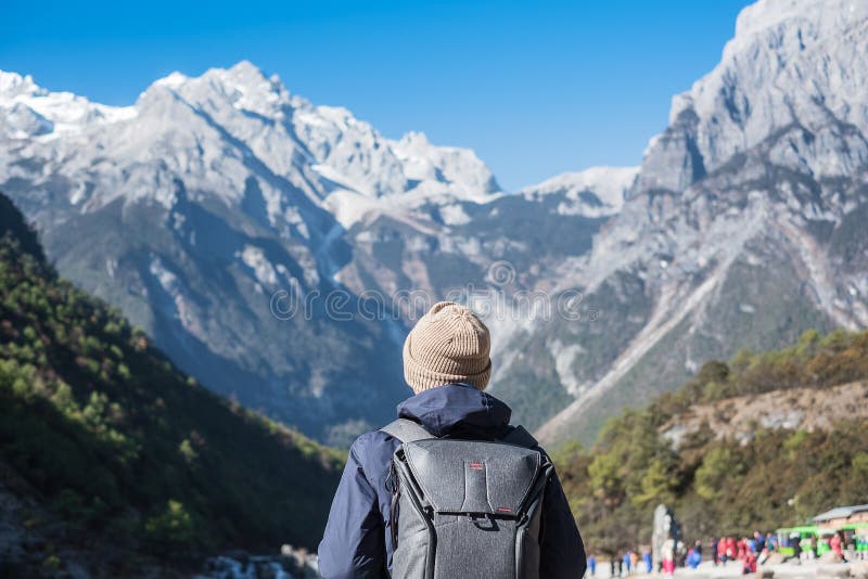Young man traveler traveling at Blue Moon Valley, landmark and popular spot inside the Jade Dragon Snow Mountain Scenic Area, near royalty free stock images Young man traveler traveling at Blue Moon Valley, landmark and popular spot inside the Jade Dragon Snow Mountain Scenic Area, near royalty free stock images