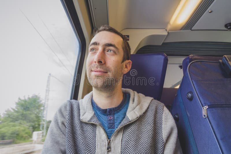 Young Man Looking Out Of Train Window Stock Photo - Download Image