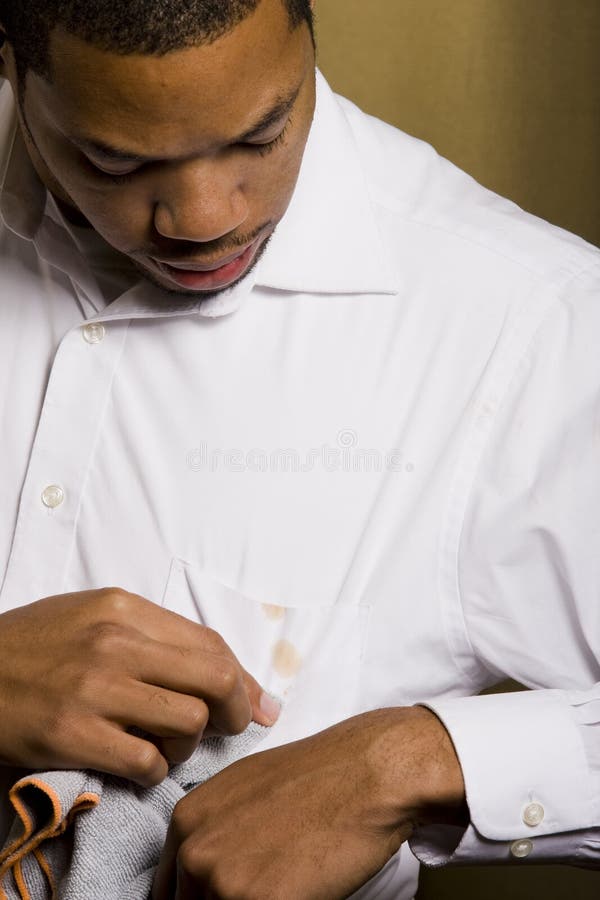 Young man trying to clean a stain