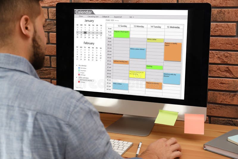 Young Man Using Calendar App on Computer in Office Stock Image Image of modern diary: 170111295 Young Man Using Calendar App on Computer in Office Stock Image Image of modern diary: 170111295