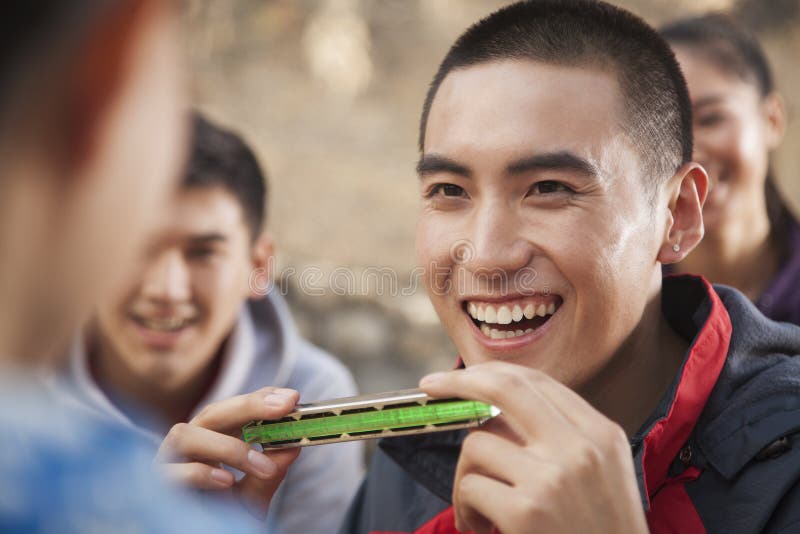 Young Harmonica Player Plays on the Street Stock Photo Image of