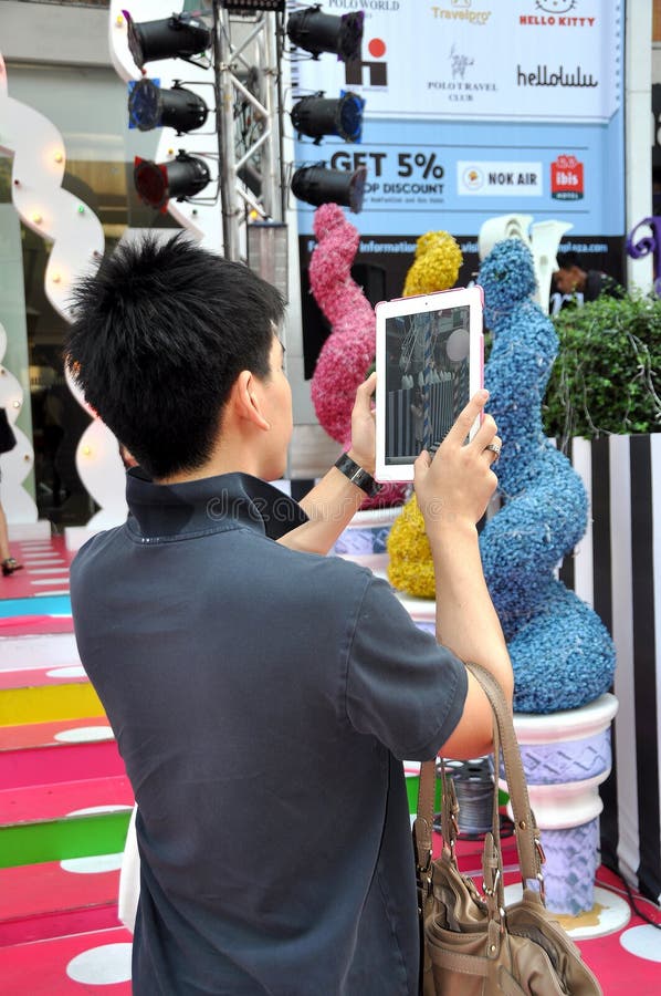 Young Man Using I-Pad for Photos stock photography