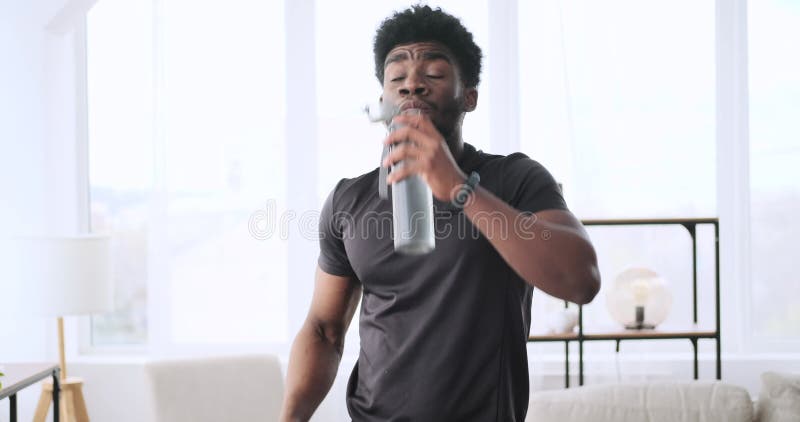 Young man using laptop while doing push up exercise stock footage