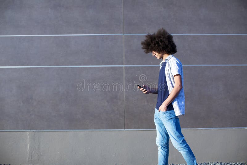 Young man using mobile phone on street