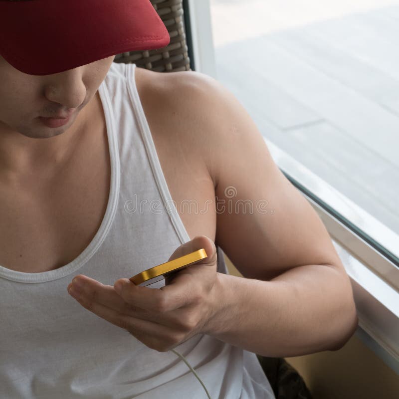 Young man using a mobile phone with texting message stock photo