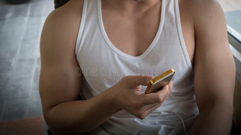 Young man using a mobile phone with texting message stock photo