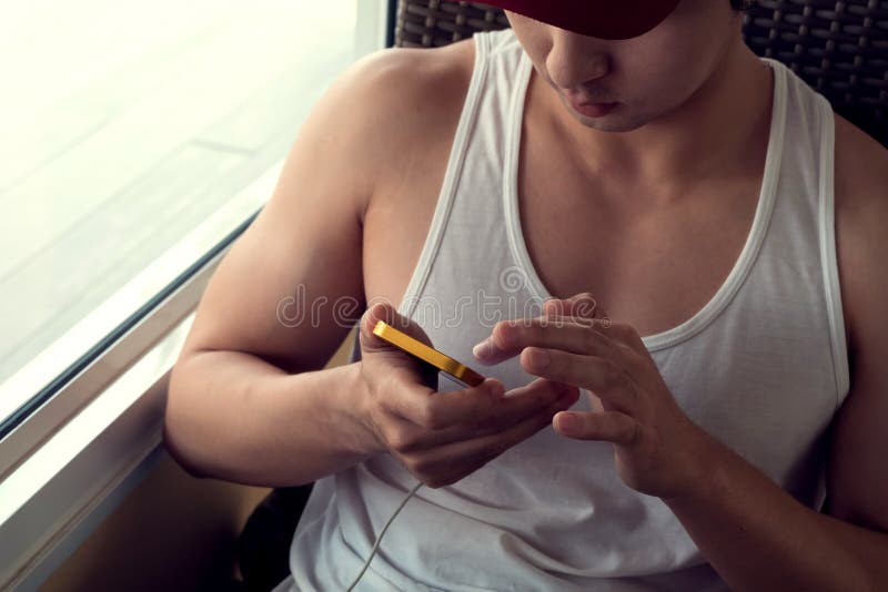 Young man using a mobile phone with texting message royalty free stock image
