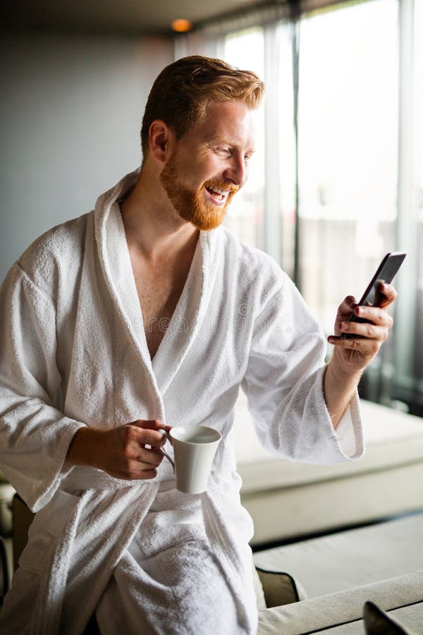 Young man using smart phone for work or to relax and reading news. Social media concept. royalty free stock image