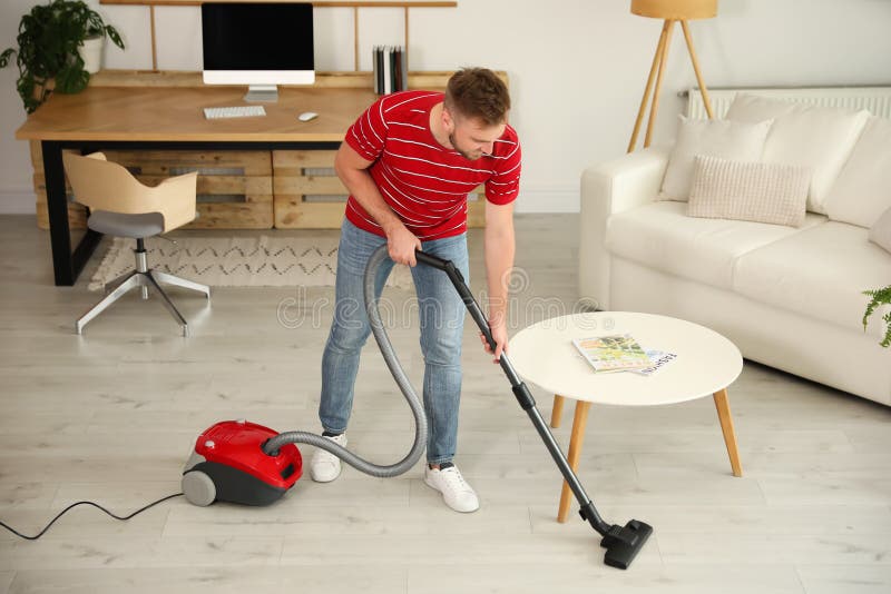 Young Man Using Vacuum Cleaner at Home Stock Image Image of lifestyle