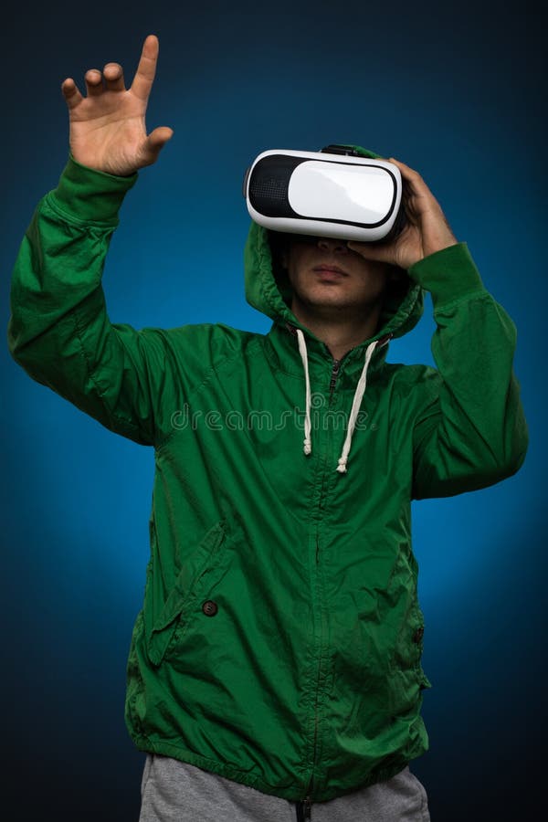 Young Man Using a VR Headset Glasses. Man with Virtual Reality Glasses