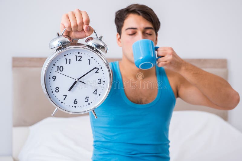 The young man waking up in bed. Night, showing.