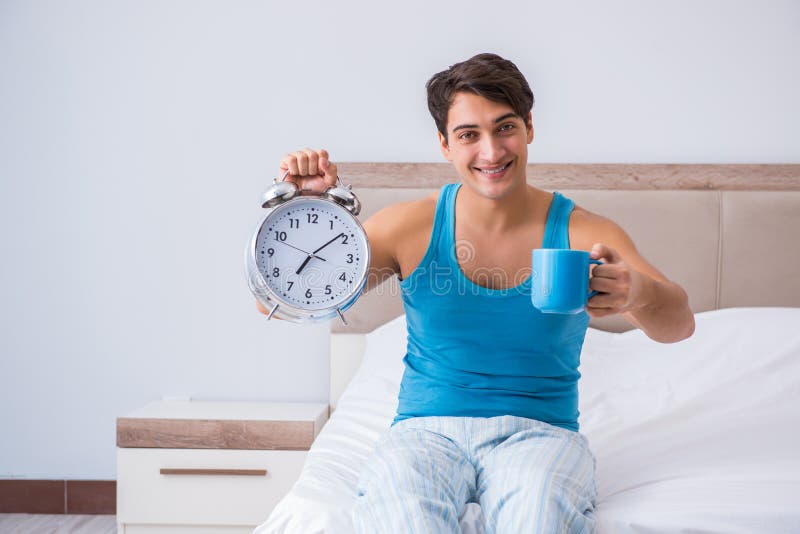 The young man waking up in bed. Routine, hotel.