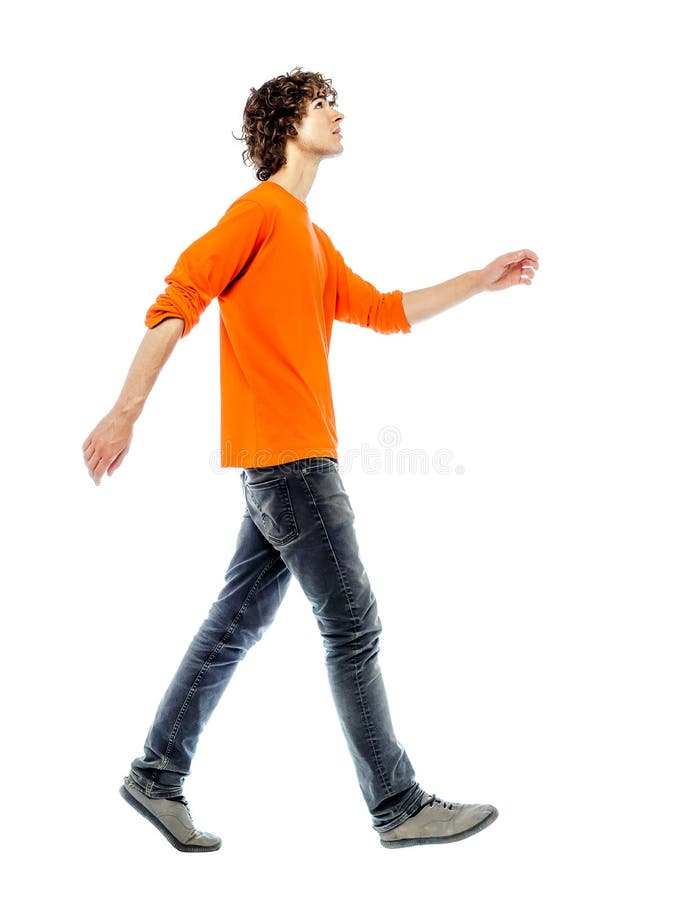 Young man walking looking up side view