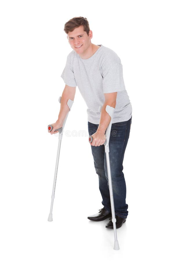 Young Man Walking with Two Crutches Stock Photo Image of brown
