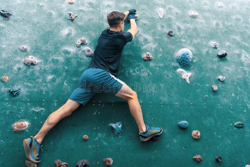 A Man Climbing in Boulder Gym in the Wall. Stock Photo Image of lead