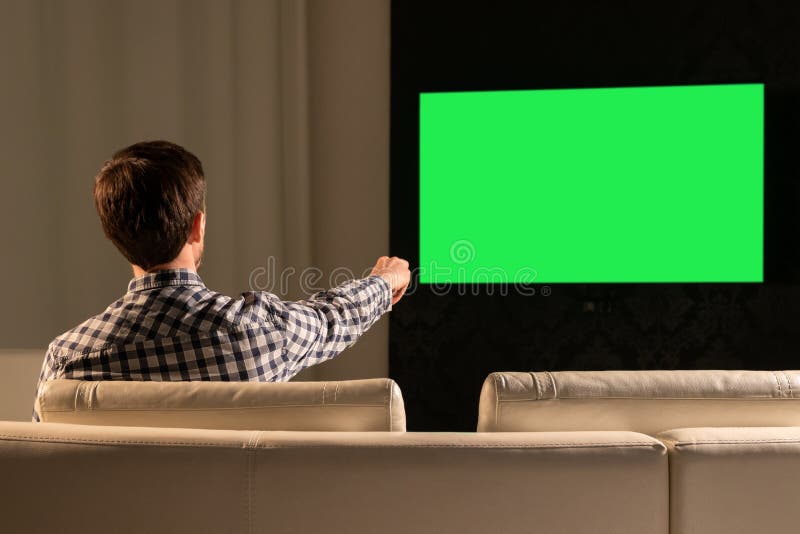 A Young Man is Watching Green Screen Stock Photo Image of dark, sofa
