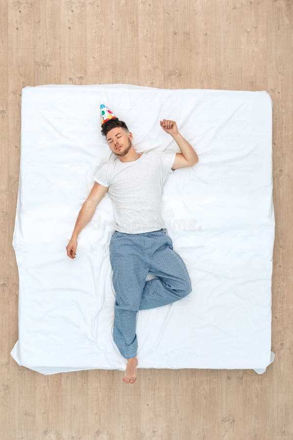 Bedtime. Guy in Birthday Cap Sleeping on Bed Top View Relaxed Stock ...