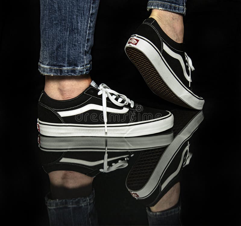 Young Man Wearing Brand New Black And White Vans Old Skool Shoes