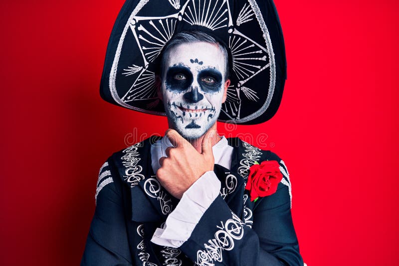 Young Man Wearing Mexican Day of the Dead Costume Over Red Looking ...