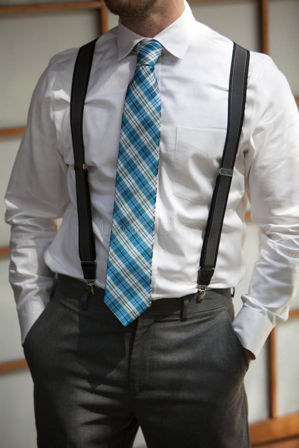 Young man wearing suspenders and colorful tie