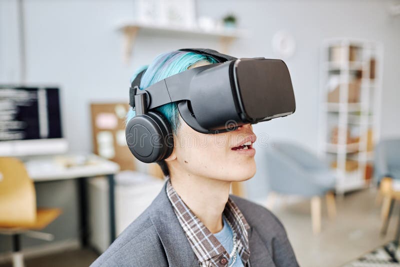 Young Man Wearing VR Headset in Office Working on Immersive Reality