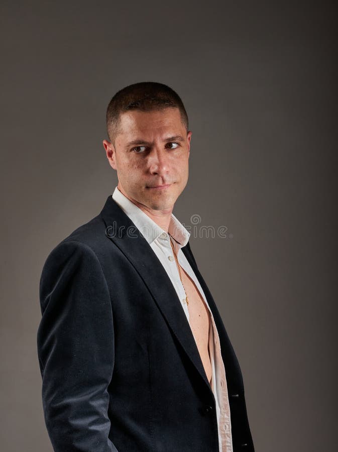 A Young Man Wearing a White Shirt and a Black Jacket Stock Image