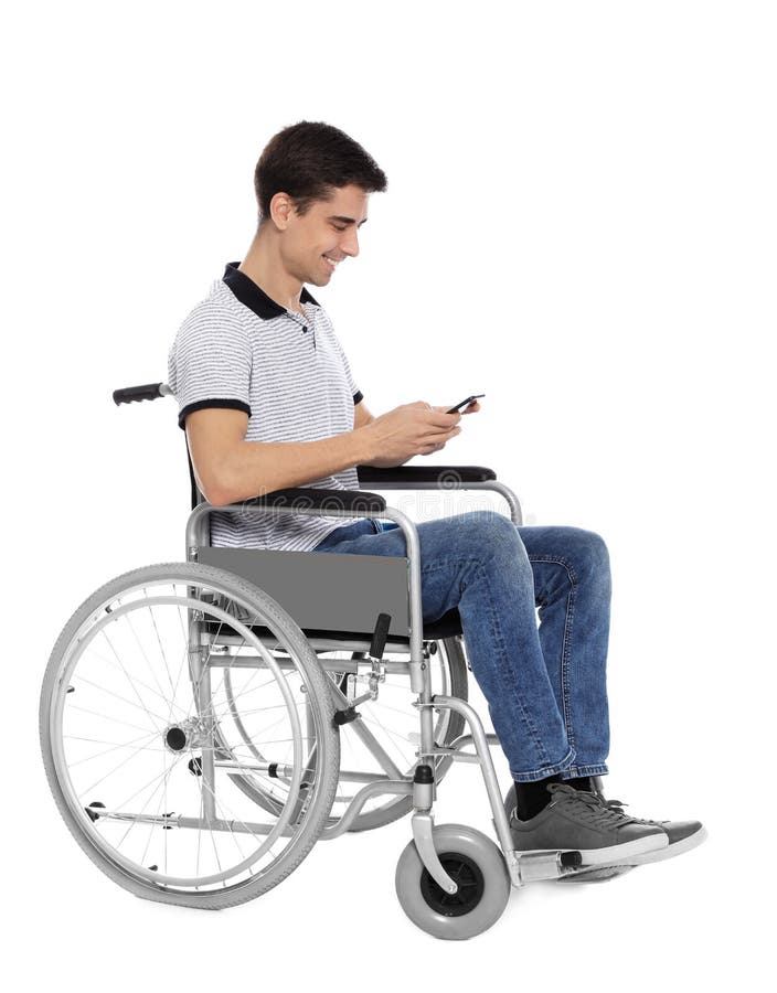 Young man in wheelchair using mobile phone isolated royalty free stock photo Young man in wheelchair using mobile phone isolated royalty free stock photo