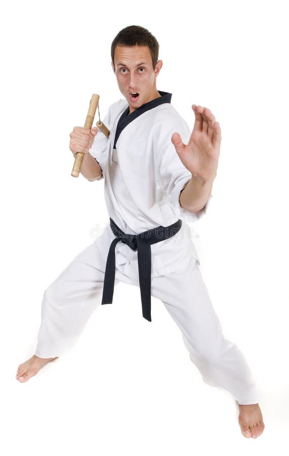 Young man in white kimono with nunchaku royalty free stock images Young man in white kimono with nunchaku royalty free stock images