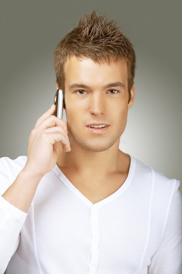Young man in white shirt talking on cell phone stock photos Young man in white shirt talking on cell phone stock photos
