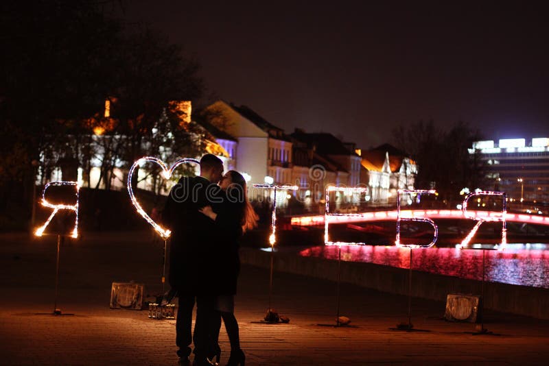 Young loving couple dancing on a night street