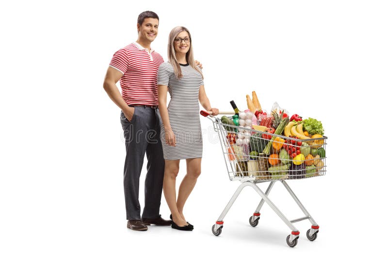 Young man and woman posing with a full shopping cart
