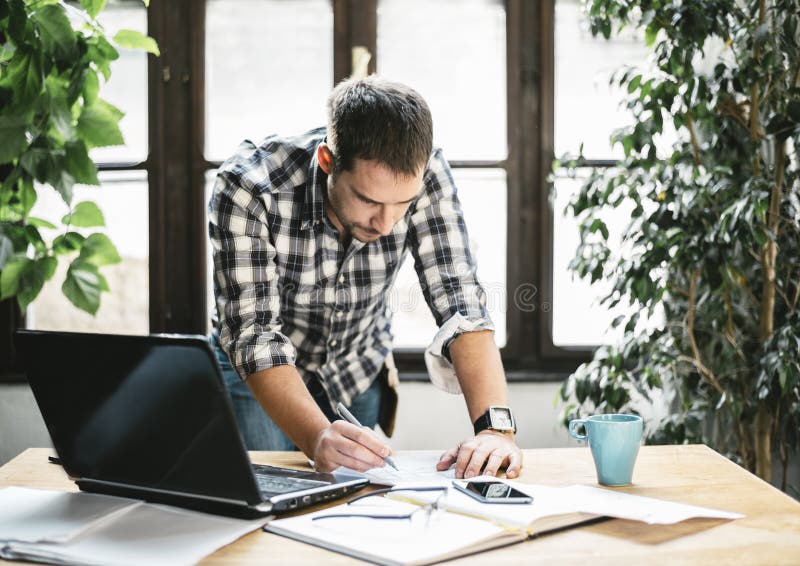 Young man work remote in his cool home office. Modern workspace studio for online business and freelance creative digital project stock images