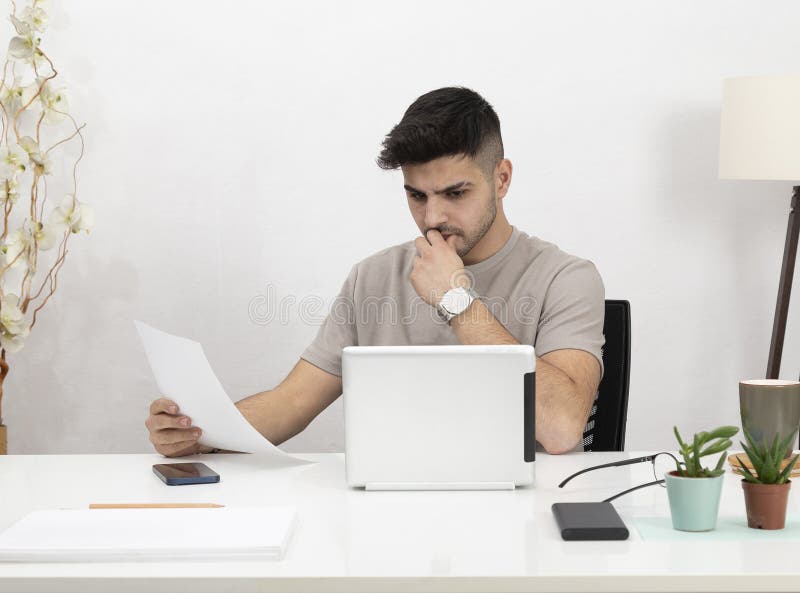 Young Man Working in Home Stock