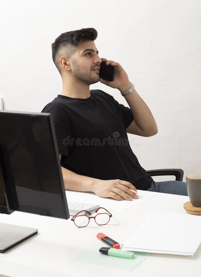 Young Man Working and Talking in His Home Office.education.business.e