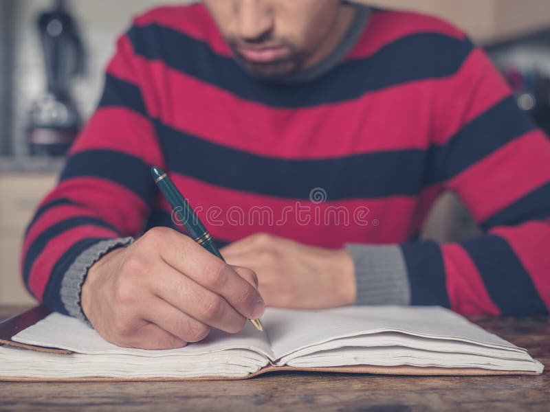 Young Man Writing in Kitchen Stock Photo Image of interior, domestic