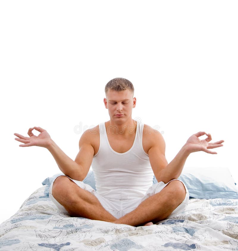 Young man in yoga meditation in bed